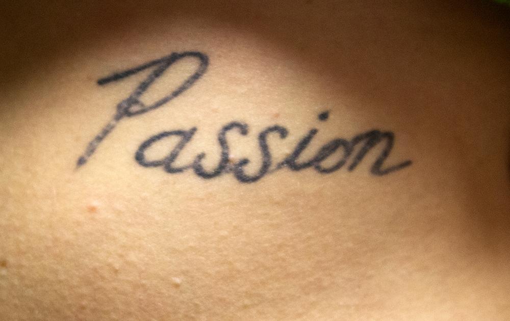 Passion lettering tattoo on the neck