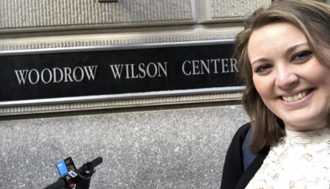 Olivia takes a selfie in front of The Wilson Center sign