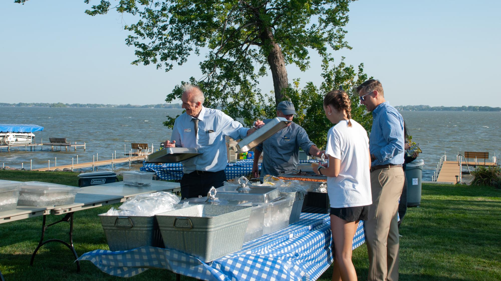 New students like Tyme Boetcher gather in BVU President Brian Lenzmeier’s backyard on September 4 for the year’s “BVQ”. Along with socialization and lawn games, students enjoy the Sodexo catering served by Corry Anderson, Scott Schwaller, Aidan Chilton, and Ken Allen. 