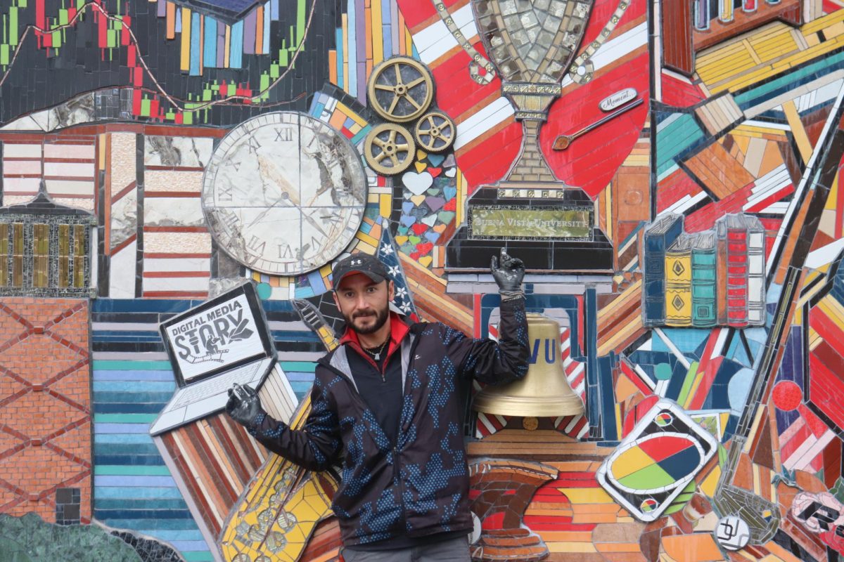 Octavio Olvera points to the two changes on the mural. 